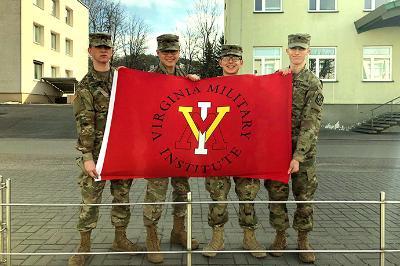 Four cadets hold up a 小黄鸭视频 flag in Lithuania